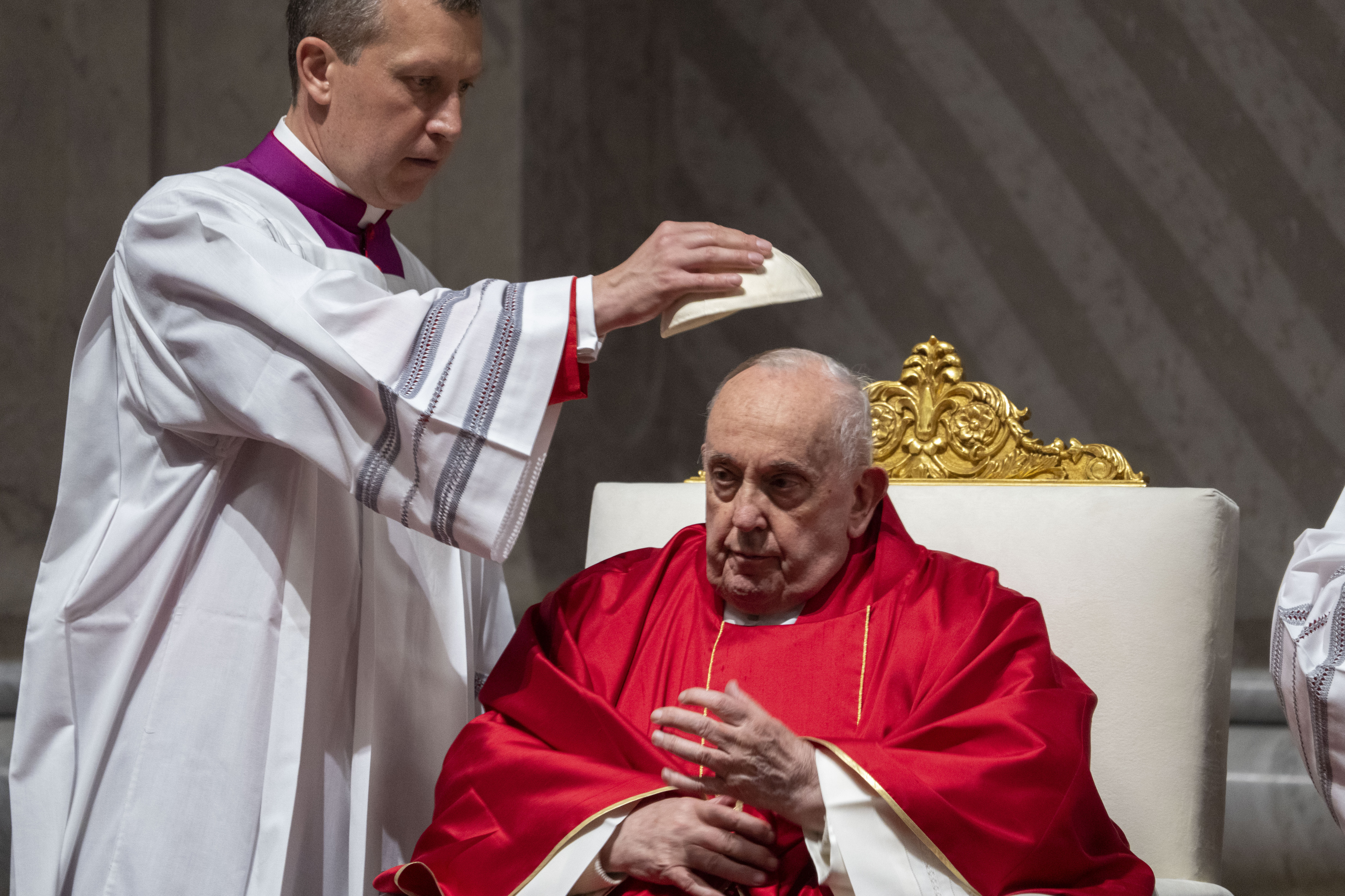 Monseñor Krzysztof Marcjanowicz le coloca el solideo al papa Francisco durante la liturgia de la pasión del Viernes Santo.