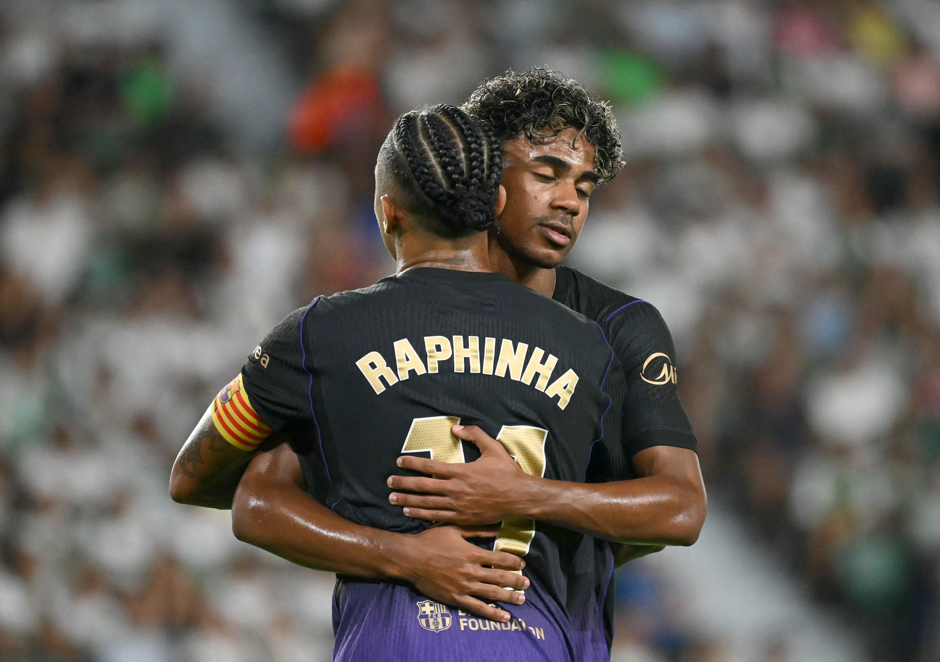 Barcelona's Brazilian forward #11 Raphinha celebrates with Barcelona's Spanish forward #10 lt;HIT gt;Lamine lt;/HIT gt; lt;HIT gt;Yamal lt;/HIT gt; scoring his team's first goal during the Spanish league football match between Elche CF and FC Barcelona at Martinez Valero Stadium in Elche on August 23, 2026. (Photo by JOSE JORDAN / AFP)
