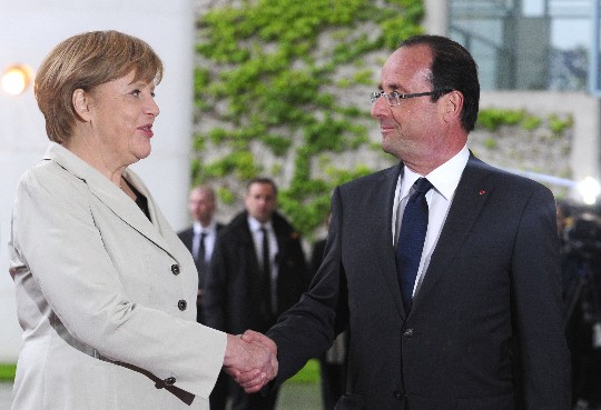Merkel y Hollande se dan la mano 