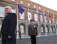 Bertie Ahern (izda.), ante las banderas de la UE. (EFE)