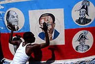 Un seguidor de Aristide cuelga un pster con la foto del ex presidente y 'hroes' nacionales.(AP)