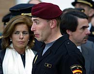 Un compañero del fallecido pasa, con el semblante muy triste, por delante de Botella y Aznar en el funeral. (AFP)