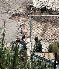 Un oficial marroquí habla con un soldado en la frontera con Ceuta tras el incidente. (AFP)