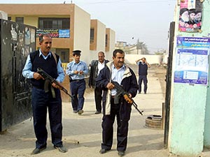 Unos policas hacen guardia a las puertas de un colegio electoral de Bagdad. (Foto: EFE)