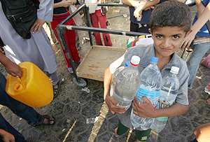 Un nio palestino coge agua en Rafah. (Foto: REUTERS)