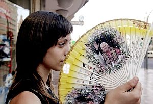 Una joven con un abanico con la figura del Papa Benedicto XVI. (Foto: EFE)