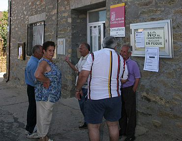 Vecinos de Peque conversan delante del ayuntamiento. (Foto: EFE)