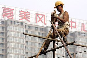 Un hombre trabaja sobre un andamio en las obras de los Juegos Olmpicos. (Foto: EFE)