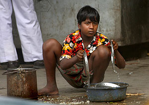 Un joven lava los platos en un puesto de comida rpida de un mercado del norte de Calcuta, India. (Foto: EFE)