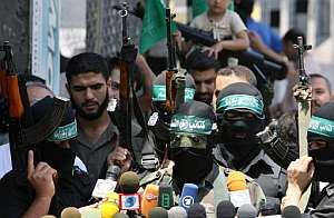 El portavoz de la milicia Azedin Al Kasam, Abu Obaida, da una rueda de prensa en una calle de Gaza. (Foto: AFP)