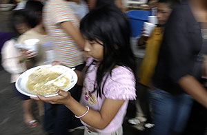 Una nia recibe un plato de comida en un albergue preparado por la alcaldia de la Ciudad de Guatemala. (EFE)
