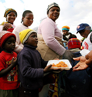 Un grupo de zimbabueses hace cola para recibir comida. (Foto: EFE)