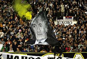 Un aficionado del Partizn ondea una bandera con una foto de Karadzic durante un partido amistoso contra el Olympic de Lyn. (Foto: AFP)