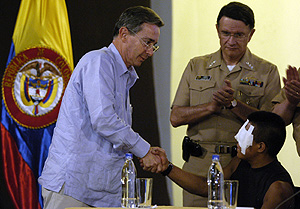 El presidente de Colombia, lvaro Uribe, da la mano a alias "Isaza", el guerrillero que custodi a scar Tulio Lizcano. (Foto: EFE)