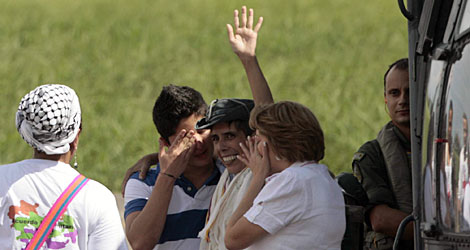 Jara (centro), abrazado por su esposa y su hijo. A la izda, la senadora Córdoba. | Efe