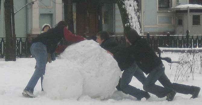 Escena kafkiana: muchachos arrastran bolas de nieve con afn de escarabajos peloteros.