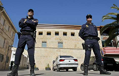 Dos policas custodian la entrada del Ayuntamiento de La Muela. | Efe