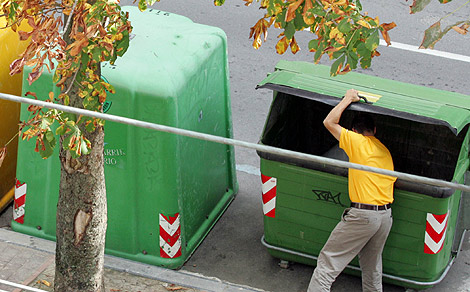 Un ciudadano deposita basura en un contenedor. | Justy Garca