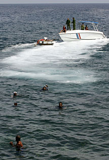 Los hombres, en el agua, despus de que les lanzasen el ancla. | Reuters
