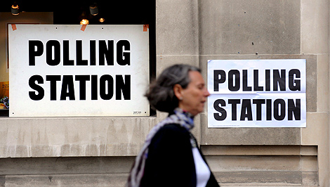 Una mujer pasa por delante de un coleio electoral en Londres. | Efe