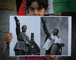 Una niña sostiene una foto que compara a Hitler con Ahmadineyad (Foto: AFP).