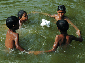 Unos nios se refrescan en una laguna de Amritsar, India, donde la temperatura ha alcanzado los 48 C en los ltimos das. | Topshots / Afp