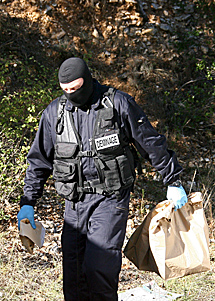 Un polica francs traslada material encontrado en el zulo. | Efe