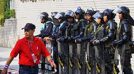 Un manifestante junto a un grupo de policas antidisturbios. | Efe