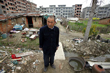 El granjero Xiang Wen Jiang permanece en su casa, rodeada de nuevas construcciones en Gushi provincia de Henan. | Reuters