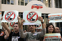 Manifestantes ante la sede del PP. | J. Cullar