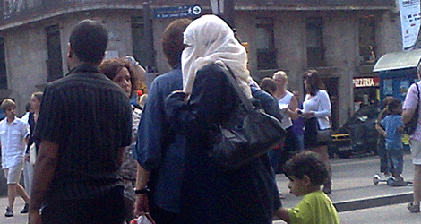 Una mujer ataviada con 'niqab' camina por una calle de Barcelona.