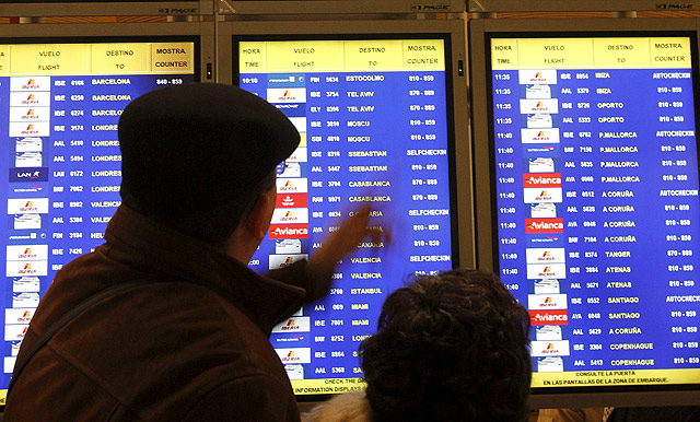 Pasajeros miran las pantallas de los vuelos. | Reuters