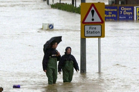 Una pareja camina por una calle inundada del sur de Gran Bretaa en el ao 2000.