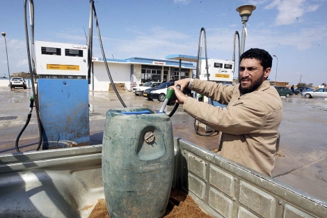 Un hombre llena un barril de gasolina en una ciudad petrolfera de Libia. | Efe