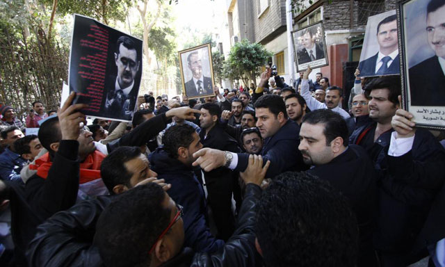 Detractores y simpatizantes del presidente Asad, a las puertas de la embajada siria en El Cairo. | Ap