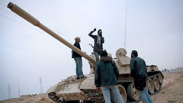 Insurgentes junto a un tanque capturado al ejrcito de las fuerzas de Muamar el Gadafi, en Ajdabiya. | Efe