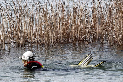 Un buceador del cuerpo de bomberos rastrea la laguna donde ha aparecido el cadver. | Efe