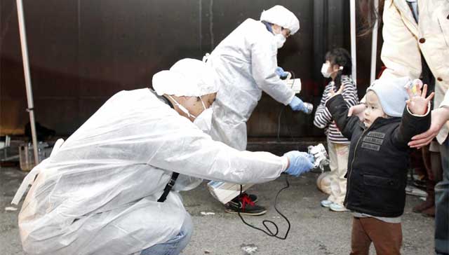 Funcionarios miden la radiactividad de varios niños tras el terremoto. | Reuters.