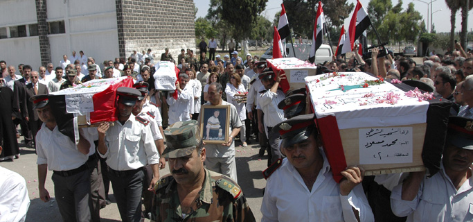 Funeral por varios miembros de las fuerzas de seguridad y el ejrcito muertos en Homs. | AP