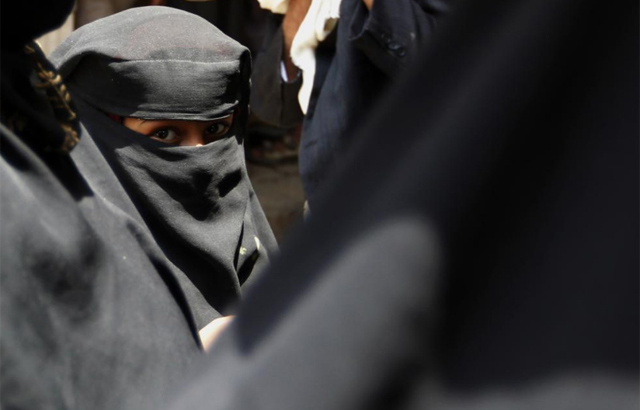 Una nia pasea por las calles de San, Yemen. | Reuters