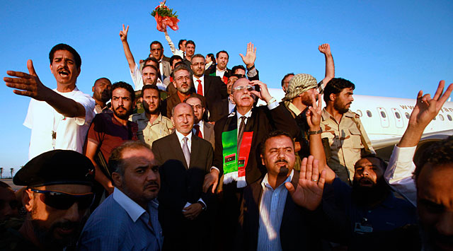 Mustafa Abdel Jalil (en el centro, con corbata de color claro), a su llegada a Trpoli. | Reuters