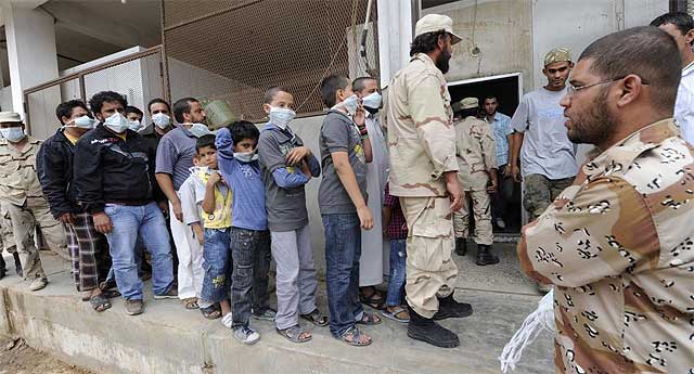 Hombres y nios esperan para ver el cuerpo en Misrata.| afp