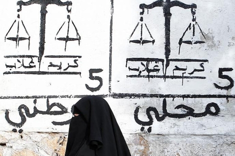 Una mujer pasa ante un cartel electoral en Casablanca. | Ap