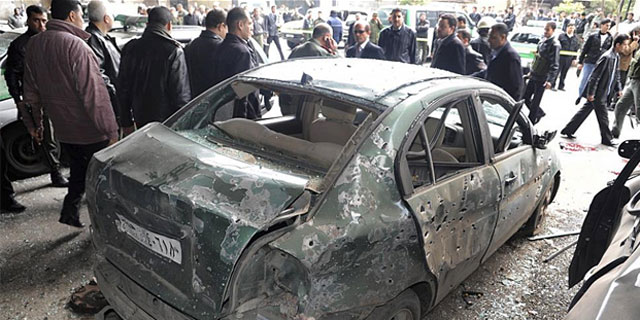 Un coche calcinado tras el atentadon en Damasco.| Efe