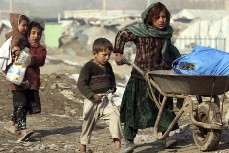 Nios afganos caminan por el campo de refugiados de Kabul. | Efe