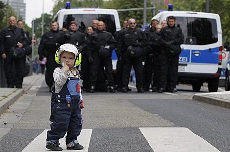 Un nio pasa frente a parte del dispositivo policial. | Reuters