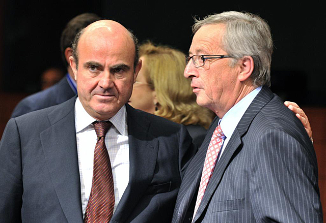 Luis de Guindos (izq.), junto al presidente del Eurogrupo, Jean-Claude Juncker. | Afp