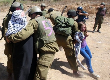 Una nia palestina protestando ante soldados israelies. | Afp