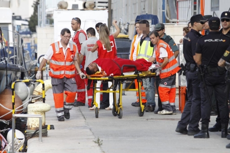 Los servicios sanitarios atienden a un inmigrante en el puerto de Alicante. | R.Prez