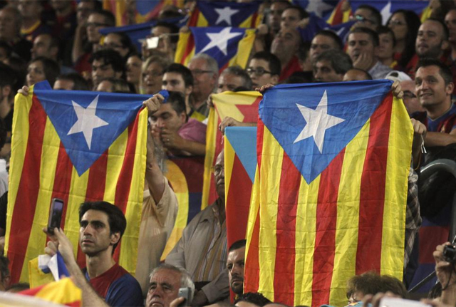 Espectadores alzan 'estelades' mientras entonan el grito de "independencia". | Reuters